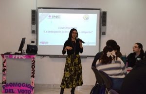 Vocal de capacitación hablando con micrófono en mano durante conversatorio