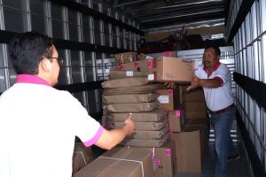 Integrantes del INE pasándose cajas con material electoral