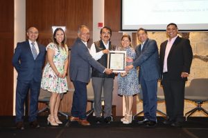 personas de pie mostrando un documento