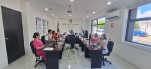 personas del consejo local sentados y votando con mano alzada