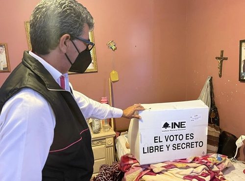 funcionario del INE en Baja California ayudando a una persona en estado de postración