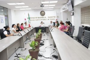 personas del consejo local sentados en labores en la sala de sesiones