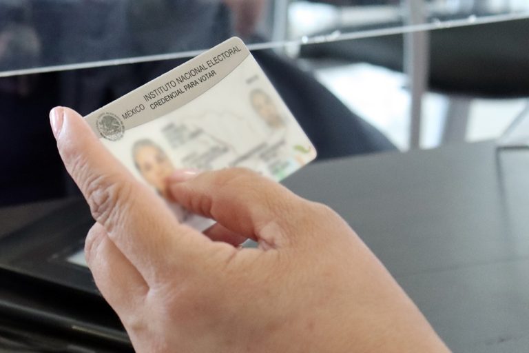 Se muestra una mano sosteniendo una credencial para votar