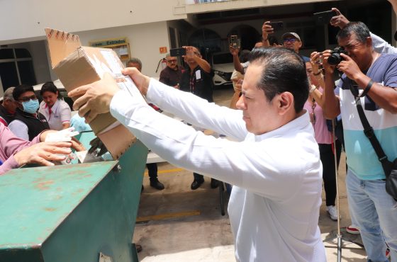 Vocal ejecutivo del INE Guerrero vertiendo credenciales para votar en una trituradora para su destrucción