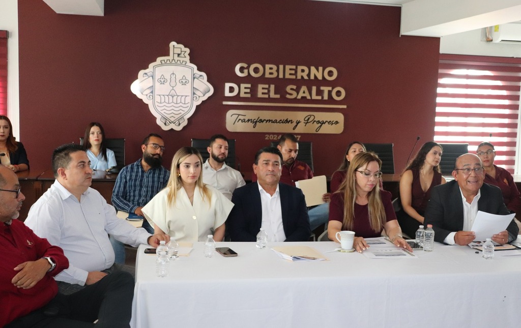 varias personas sentadas frente a una mesa con mantel blanco